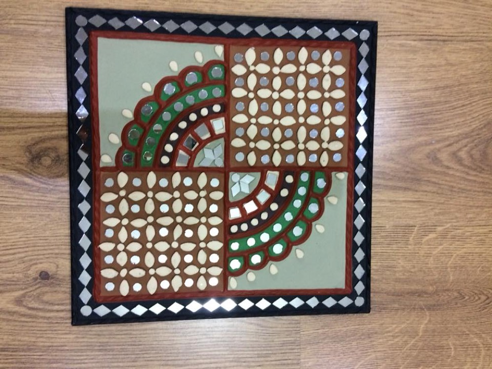 Green mud art with red design